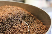 Brown coffee beans being roasted for purchase.