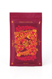 Rectangular red and yellow pouch containing birdsnake chocolate from Madagascar.